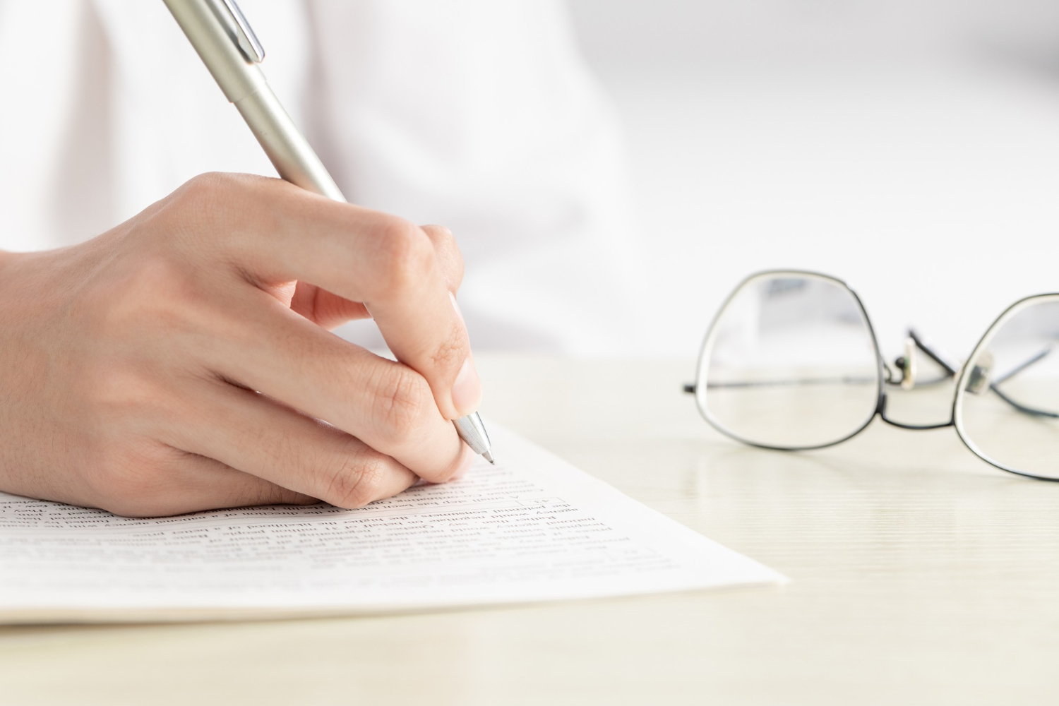 Woman is writing on the paper