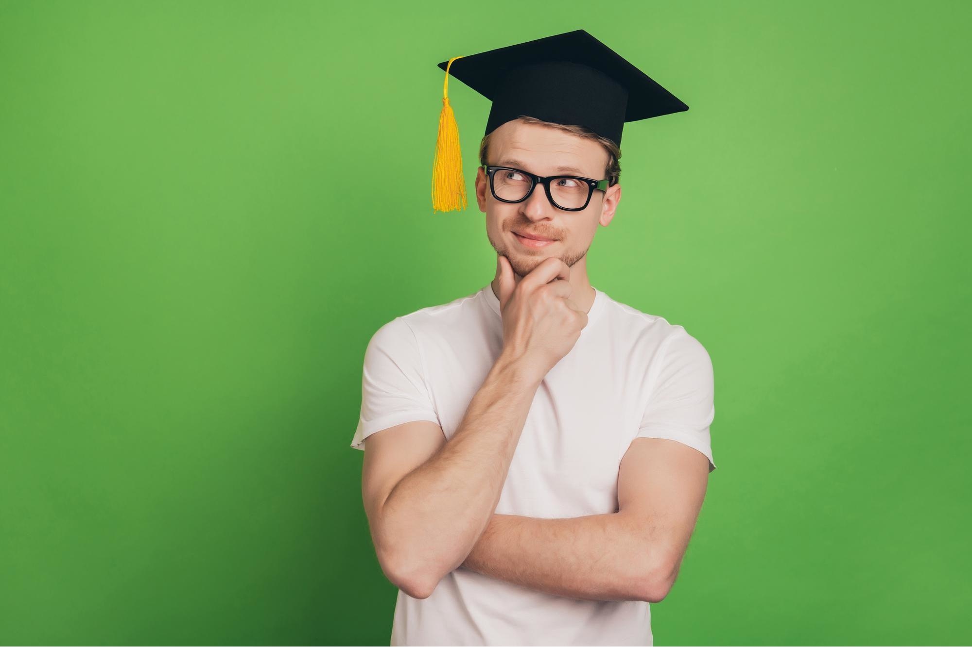 Student in the academic cap is thinking