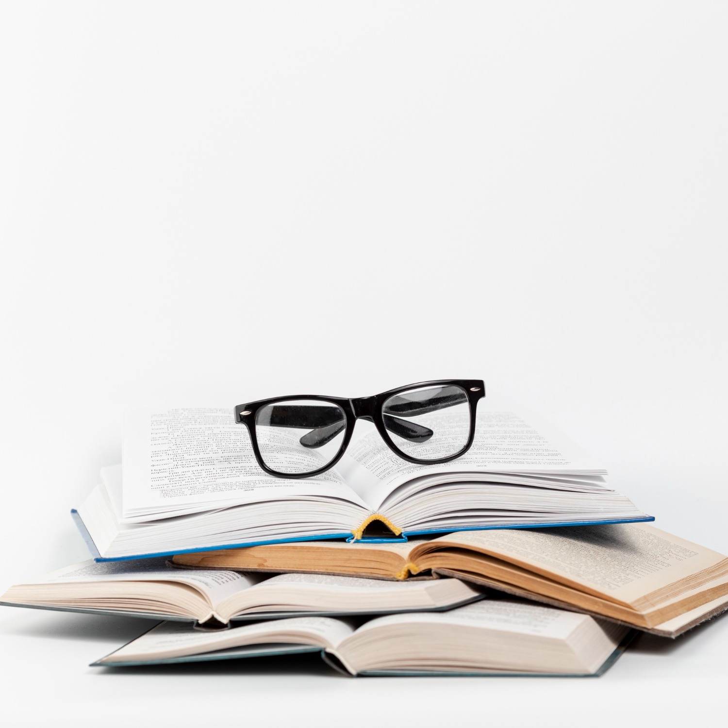 Open books with glasses on top